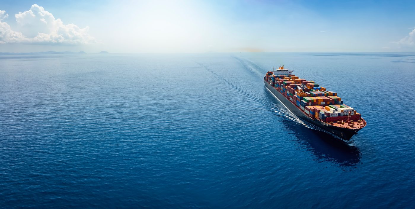 Aerial view of a container ship on deep blue ocean